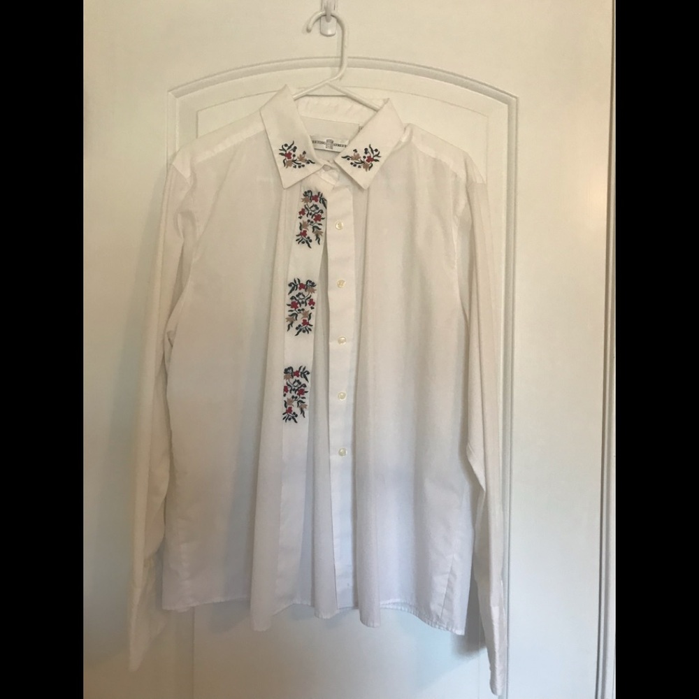Dress blouse with beautiful embroidery detail.
